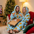Two friends sharing pizza on a Christmas movie night wearing matching Pizza Party Snugzillas
