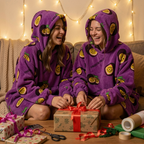 Two friends laughing while wrapping Christmas presents in matching Passion Fruit Snugzillas