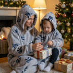 Mum and toddler in matching Raccoon Snugzillas opening a present